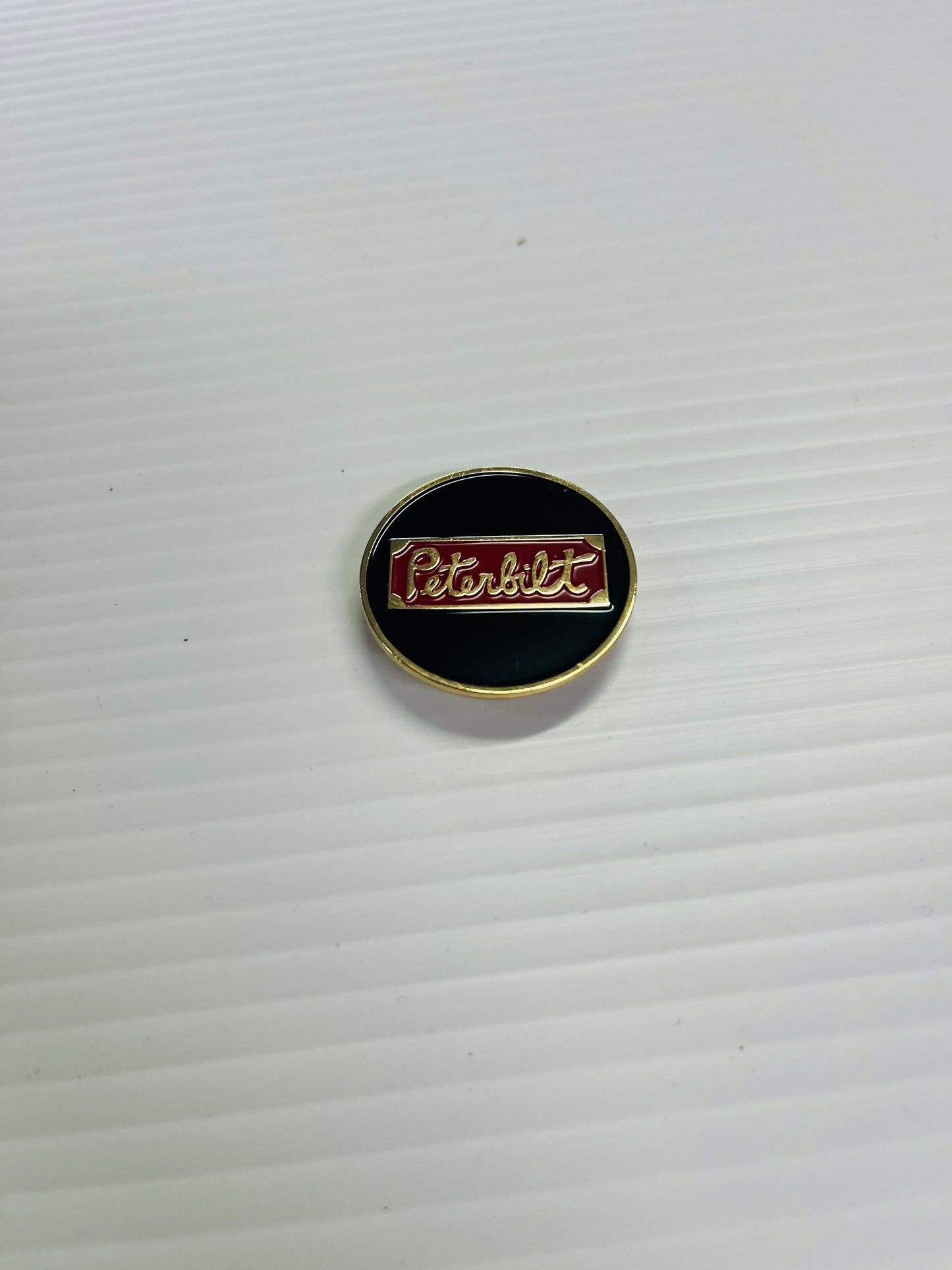 AACC - P16 - Peterbilt black/red/brass round Horn Honker Medallion