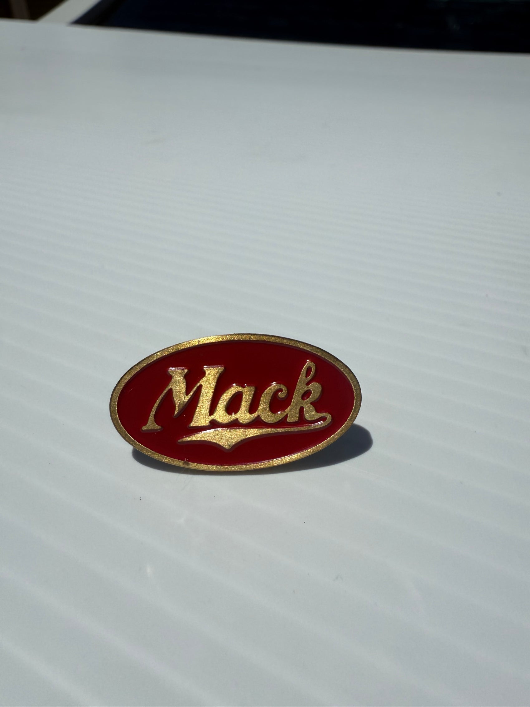 AACC - M6 - Mack red/brass oval Horn Honker Medallion